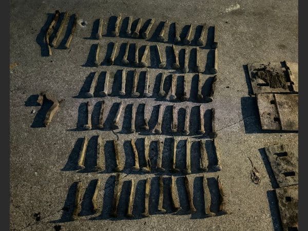 Magnet fishing find: Rows of metal hardware laid out after a haul