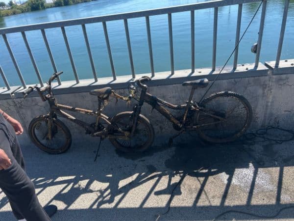 Two bikes pulled from the river onto a bridge