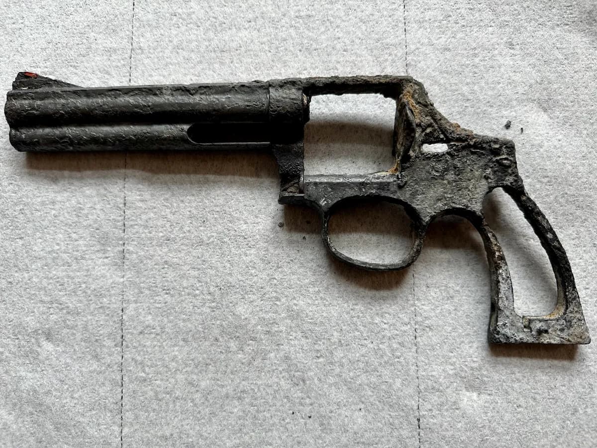 A corroded revolver missing its cylinder, trigger, and grips, pulled from the Willamette River
